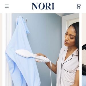 NORI Handheld Fabric Steamer in White - Light Blue Shirt